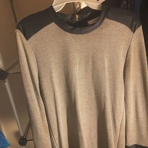 Black and white top with leather neck and cuffs zipper on back